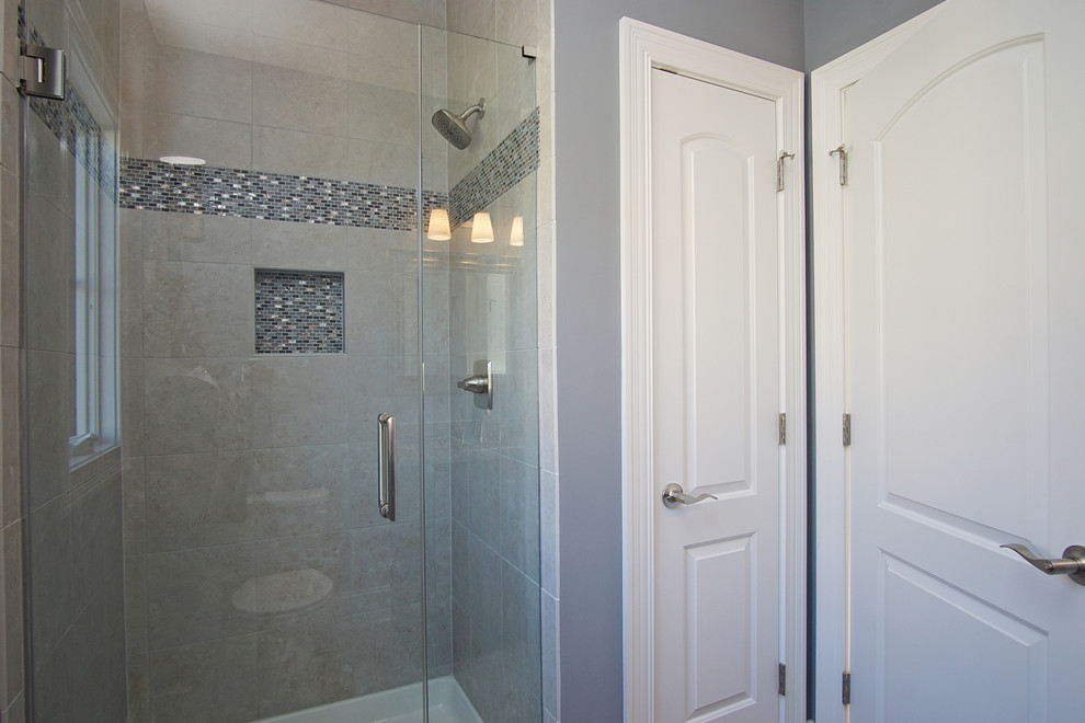 Inspiration for a transitional beige tile and ceramic tile ceramic tile doorless shower remodel in Chicago with recessed-panel cabinets, brown cabinets, a two-piece toilet, gray walls, an undermount sink and granite countertops
