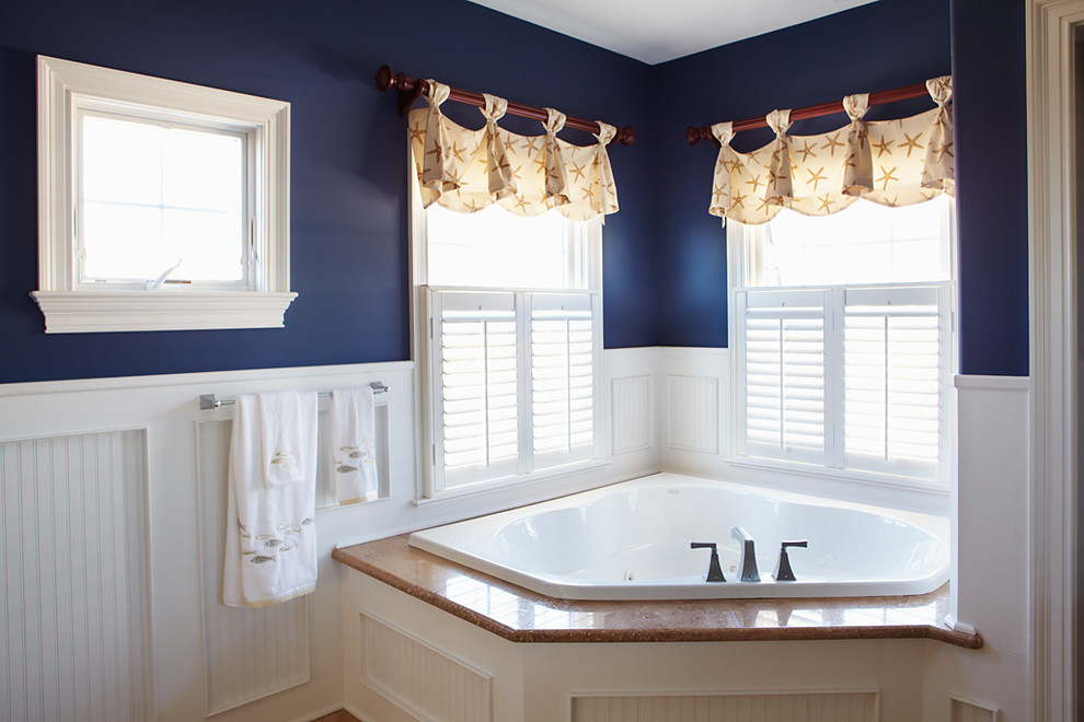 This is an example of a large traditional master bathroom in Philadelphia with a drop-in tub and blue walls.