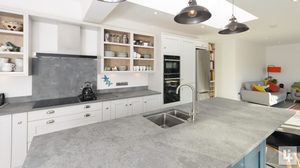 Large contemporary eat-in kitchen in Other with an undermount sink, shaker cabinets, blue cabinets, quartzite benchtops, grey splashback, with island, grey floor and grey benchtop.