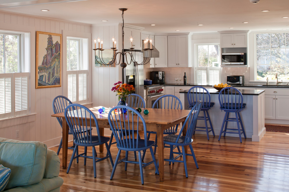 Mid-sized beach style open plan dining in Boston with beige walls, medium hardwood floors and no fireplace.