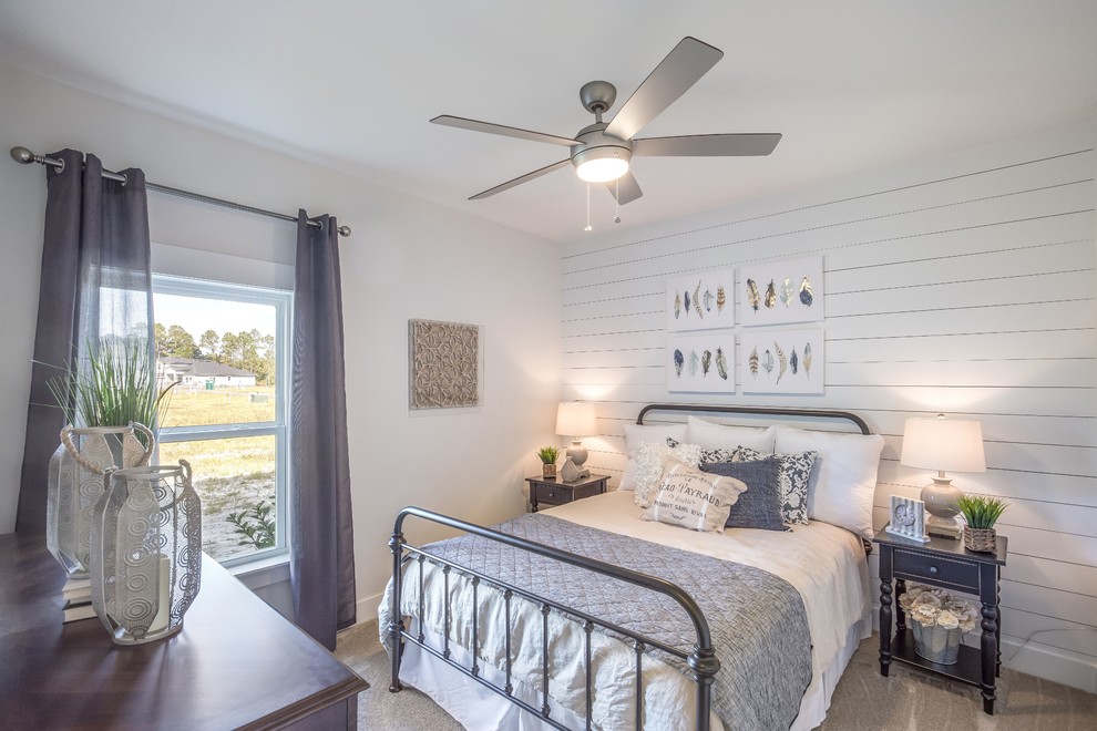 This is an example of a transitional bedroom in Jacksonville with white walls, carpet and beige floor.