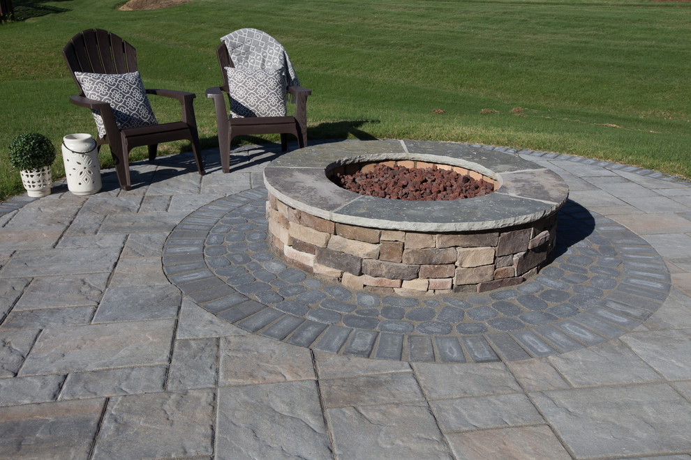 This is an example of a small contemporary backyard patio in Charlotte with a fire feature, concrete pavers and no cover.