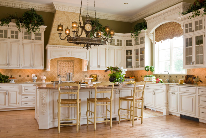 Inspiration for a mid-sized rustic l-shaped light wood floor and beige floor kitchen pantry remodel in DC Metro with raised-panel cabinets, beige backsplash, an island, a farmhouse sink, white cabinets, granite countertops, ceramic backsplash and paneled appliances