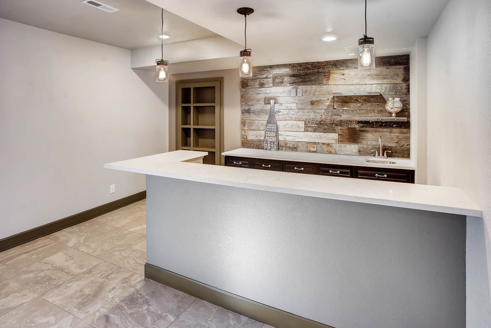 Mid-sized industrial fully buried basement in Denver with white walls, carpet, grey floor, a standard fireplace and a wood fireplace surround.
