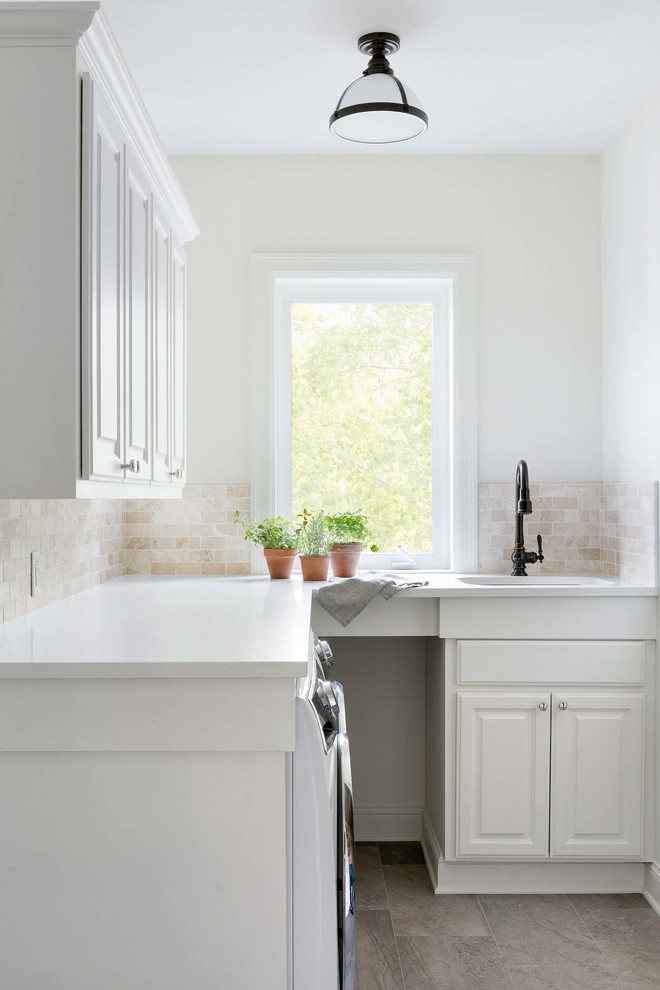 Photo of a country u-shaped eat-in kitchen in Minneapolis with a farmhouse sink, beaded inset cabinets, white cabinets, white splashback, dark hardwood floors, with island, brown floor and white benchtop.