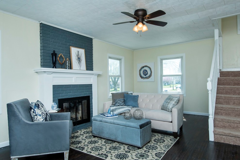 This is an example of a small transitional living room in Columbus with dark hardwood floors, a standard fireplace and a brick fireplace surround.