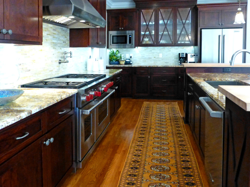 Kitchen - large transitional medium tone wood floor kitchen idea in Richmond with recessed-panel cabinets, dark wood cabinets, granite countertops, beige backsplash, ceramic backsplash, stainless steel appliances and an island