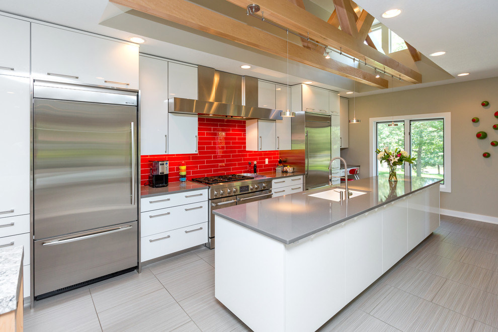 Design ideas for a contemporary galley kitchen in Other with quartz benchtops, an undermount sink, flat-panel cabinets, white cabinets, red splashback, subway tile splashback and stainless steel appliances.