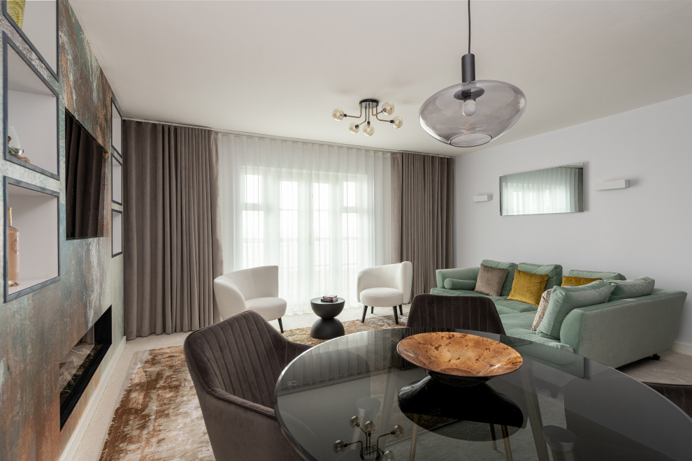 Cette photo montre un grand salon tendance avec un mur gris, moquette, une cheminée standard, un téléviseur encastré et un sol beige.