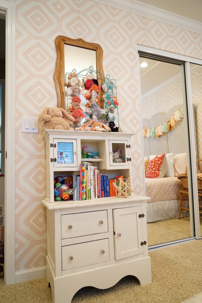 This is an example of a mid-sized traditional nursery for girls in San Francisco with multi-coloured walls and carpet.