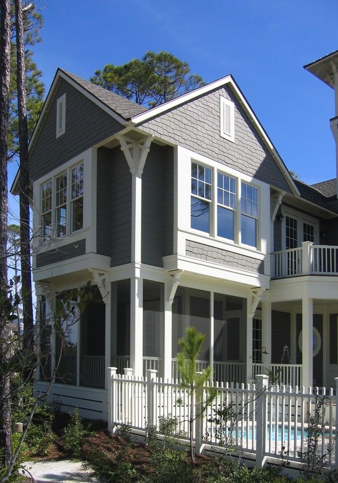 Design ideas for a beach style grey exterior in Tampa with vinyl siding and a gable roof.