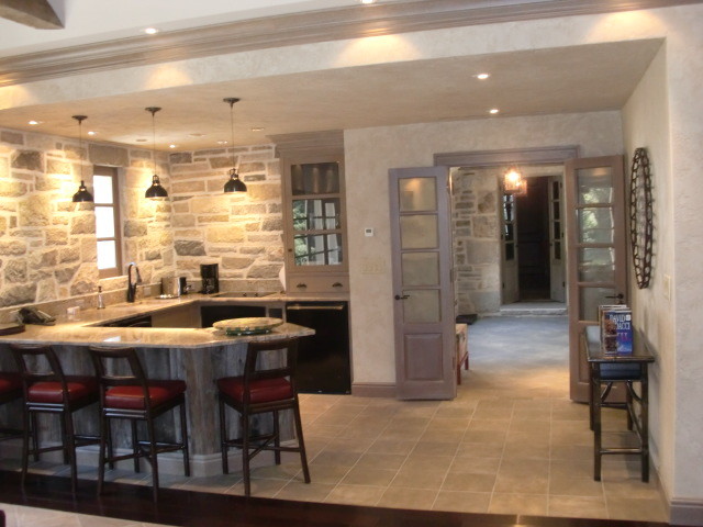 Open concept kitchen - small rustic u-shaped porcelain tile open concept kitchen idea in New York with an undermount sink, flat-panel cabinets, gray cabinets, laminate countertops, multicolored backsplash, stone tile backsplash, stainless steel appliances and an island