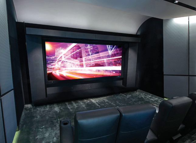 This is an example of a modern home theatre in New York with black walls and a projector screen.