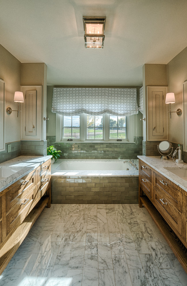 Design ideas for a mid-sized country master bathroom in Denver with shaker cabinets, granite benchtops, a drop-in tub, a two-piece toilet, green tile, glass tile, beige walls, medium wood cabinets and an undermount sink.