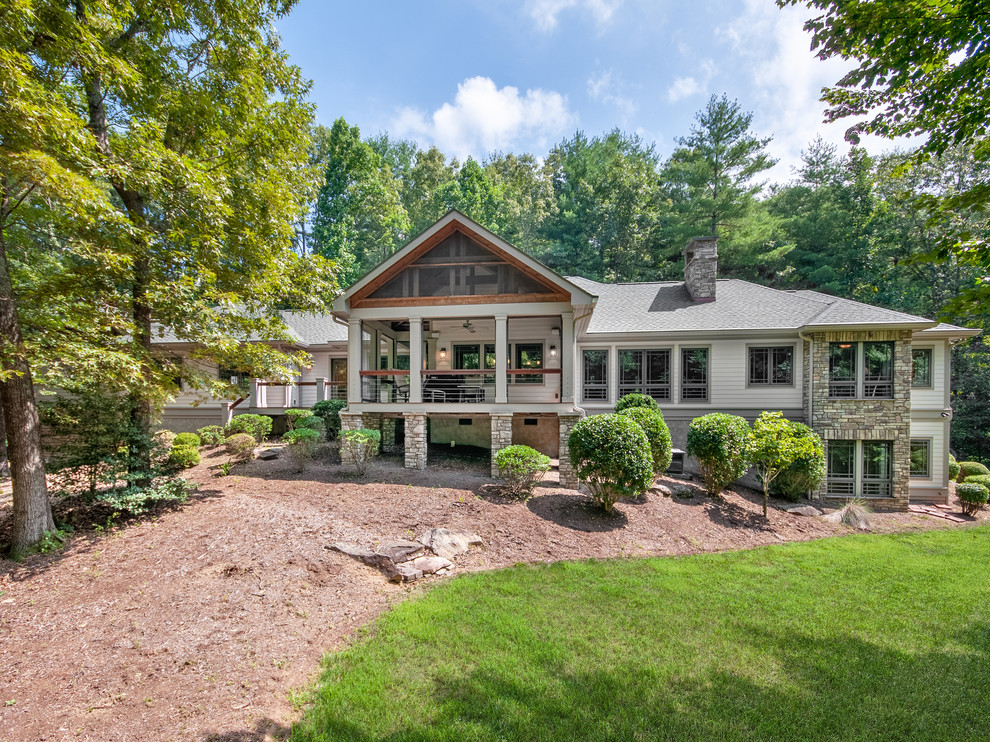 Example of a mid-sized mountain style gray one-story wood house exterior design with a hip roof and a shingle roof