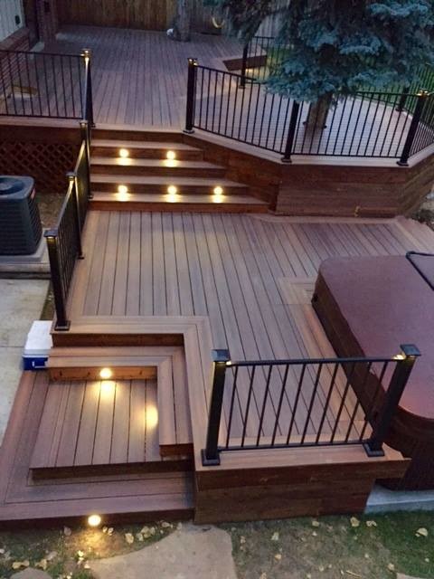 This is an example of a large arts and crafts backyard deck in Denver with no cover.