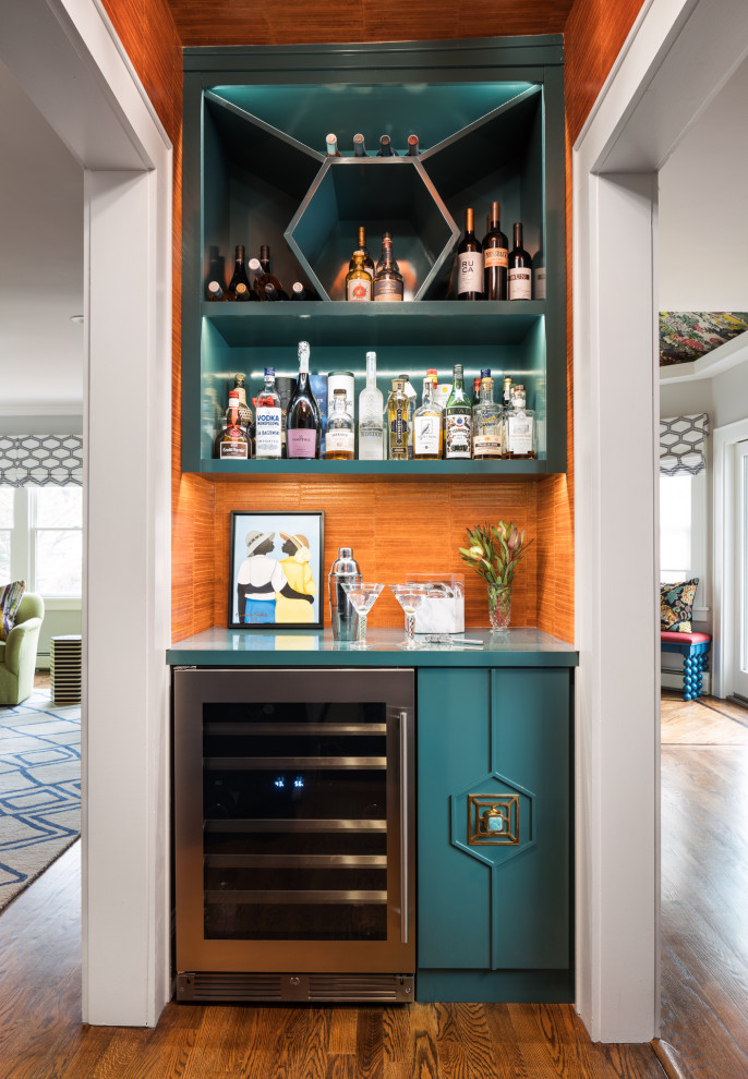 Photo of a contemporary home bar in New York with wood benchtops, orange splashback, medium hardwood floors, brown floor and turquoise benchtop.