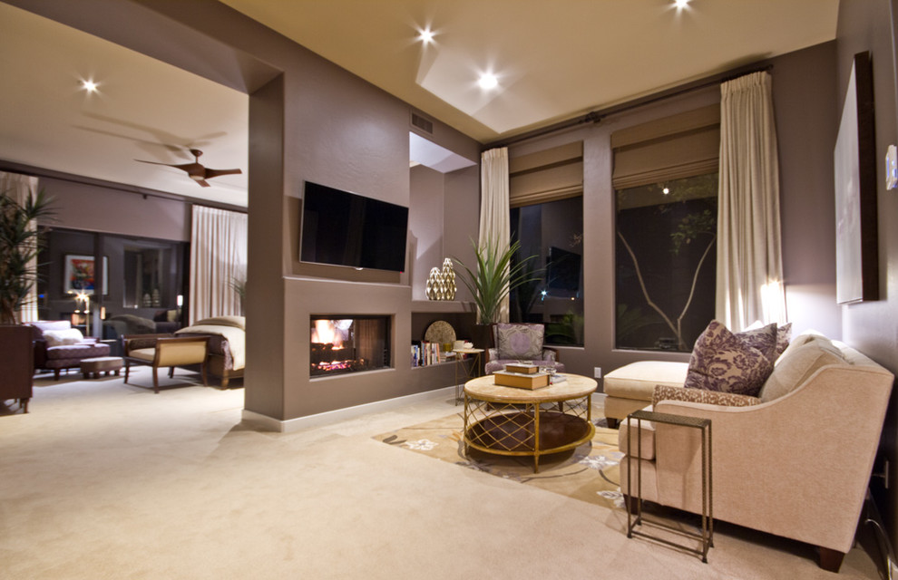 Transitional master bedroom in Phoenix with purple walls, carpet and a two-sided fireplace.