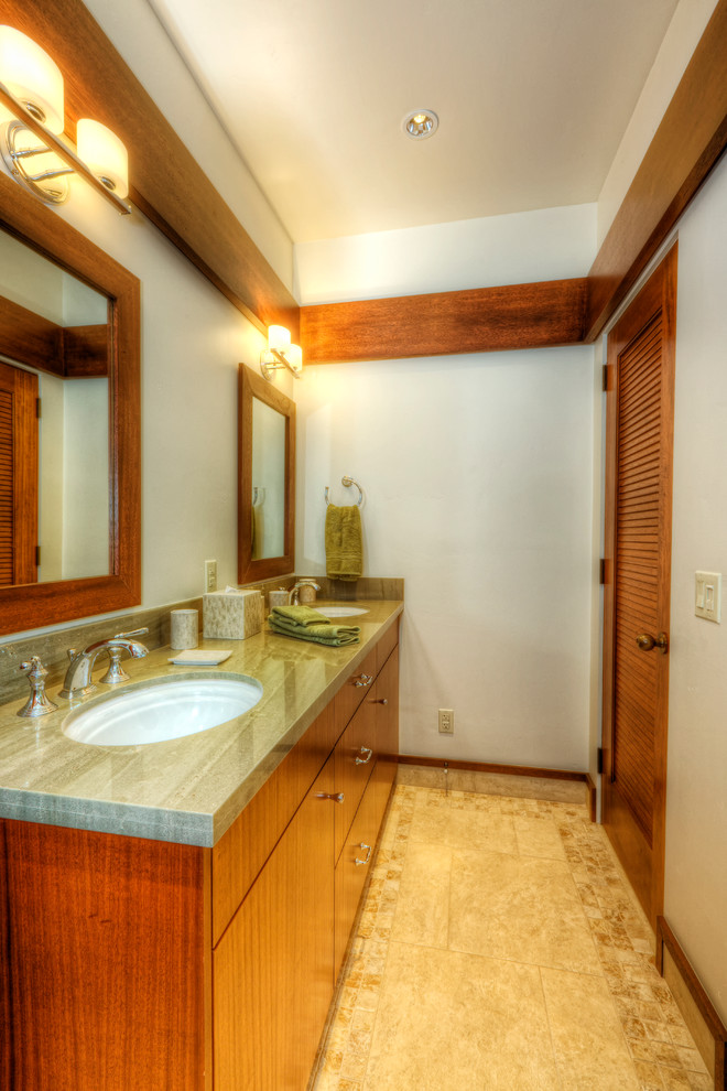 Photo of a large contemporary 3/4 bathroom in Hawaii with flat-panel cabinets, medium wood cabinets, solid surface benchtops, a two-piece toilet, white walls, ceramic floors, an undermount sink and beige floor.