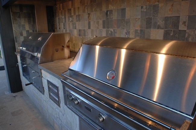 Outdoor Kitchen With Clean Concrete Countertops With Charcoal And
