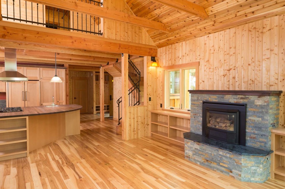 Example of an arts and crafts light wood floor open concept kitchen design with an island
