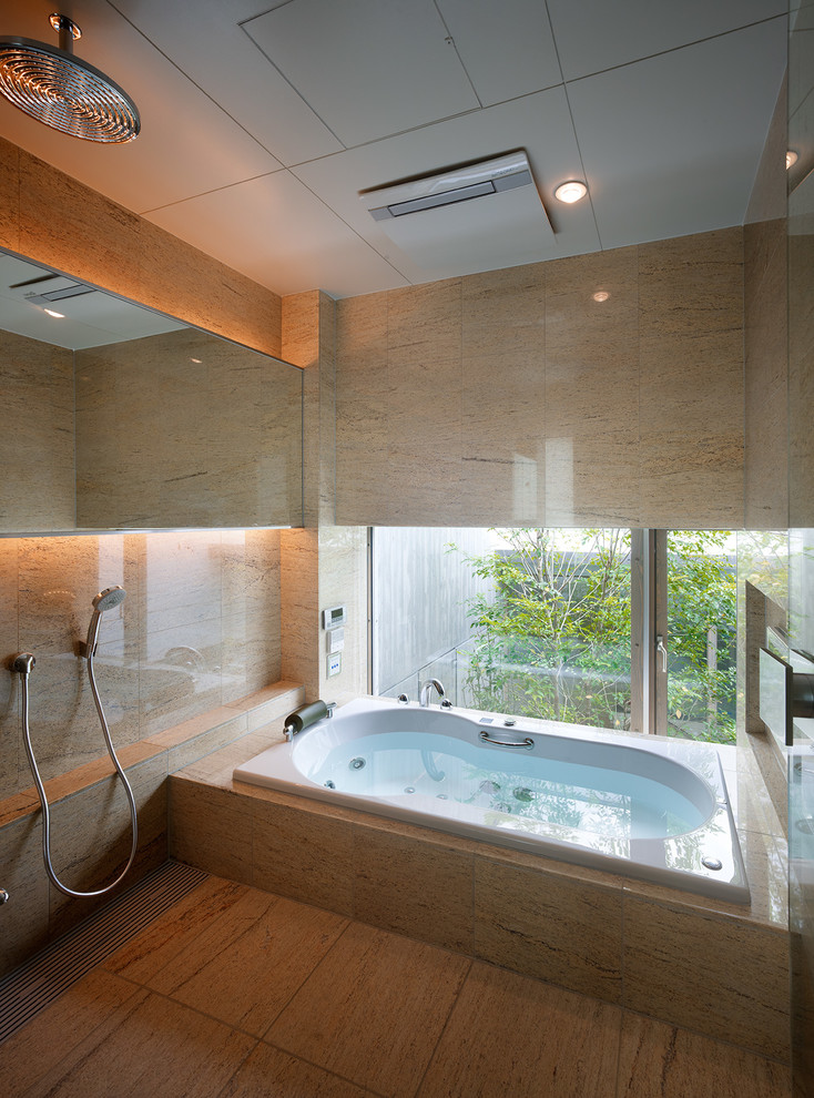 Photo of a contemporary master bathroom in Tokyo with a drop-in tub, beige walls, an open shower and an open shower.