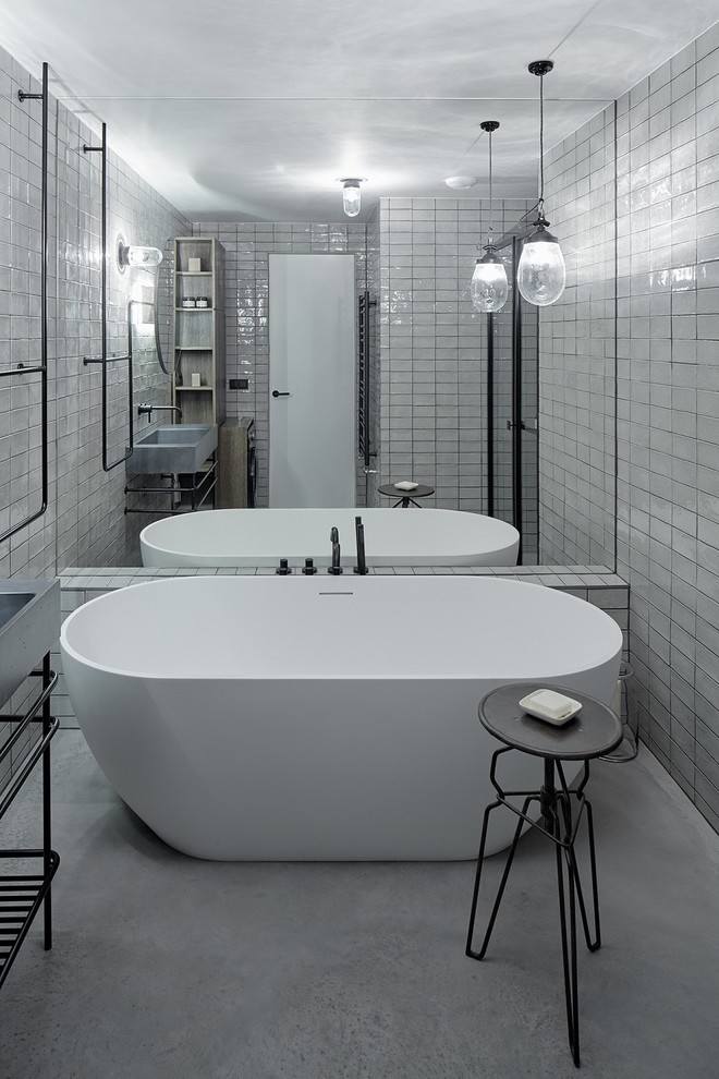 This is an example of an industrial bathroom in Other with concrete floors.