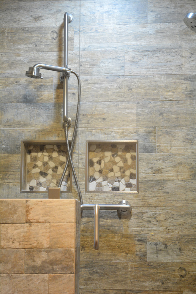 Inspiration for a mid-sized rustic master brown tile and ceramic tile ceramic tile and brown floor alcove shower remodel with raised-panel cabinets, light wood cabinets, a two-piece toilet, beige walls, an integrated sink, marble countertops, a hinged shower door and gray countertops