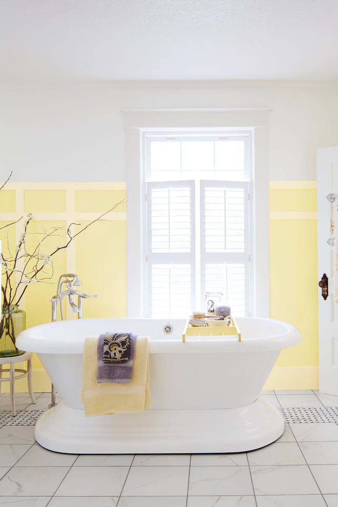 Inspiration for a large transitional master porcelain tile freestanding bathtub remodel in Charlotte with yellow walls
