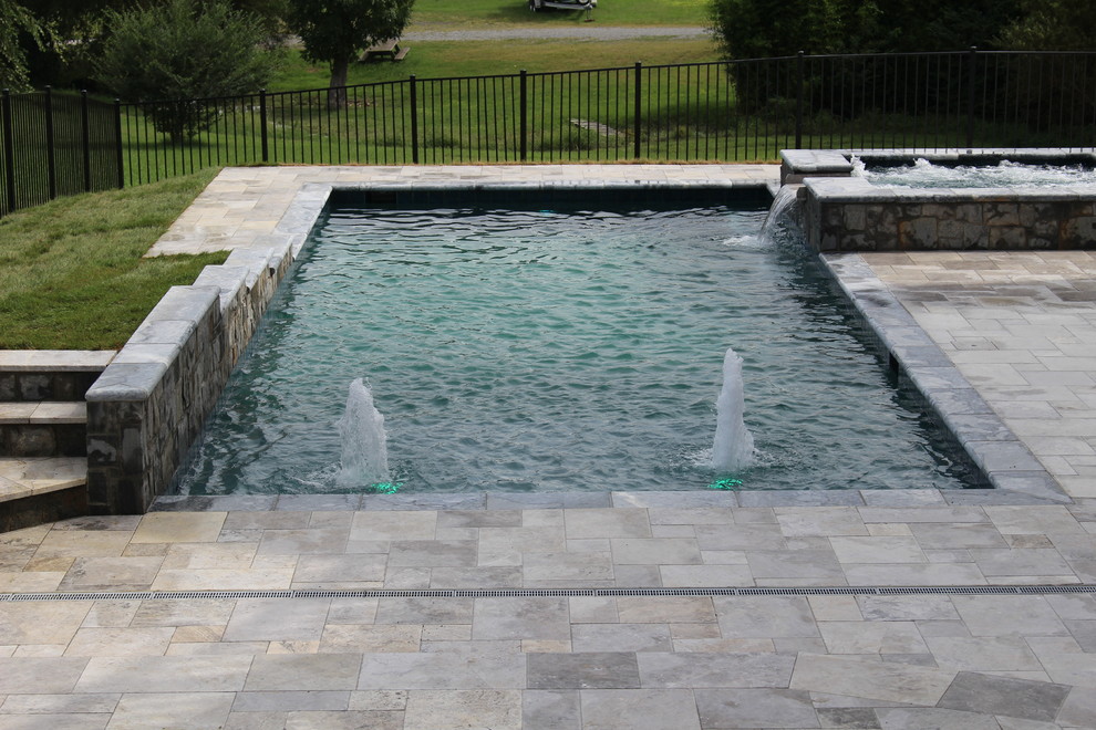 Example of a small mountain style backyard stone and rectangular natural hot tub design in DC Metro