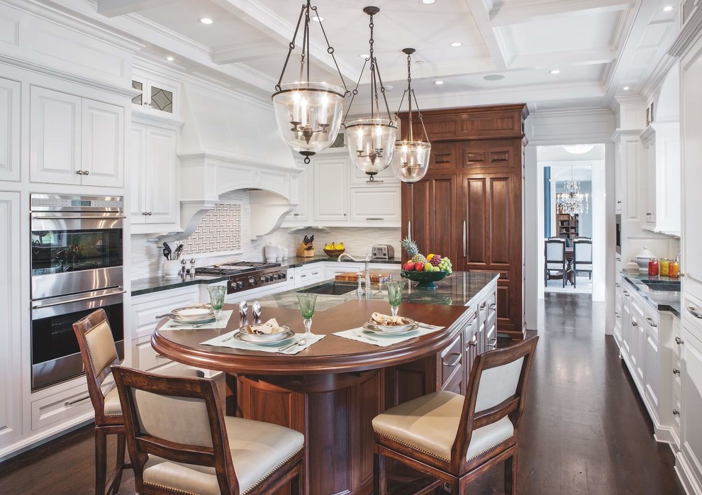 Inspiration for a large traditional separate kitchen with raised-panel cabinets, white cabinets, ceramic splashback, stainless steel appliances, dark hardwood floors, brown floor and with island.