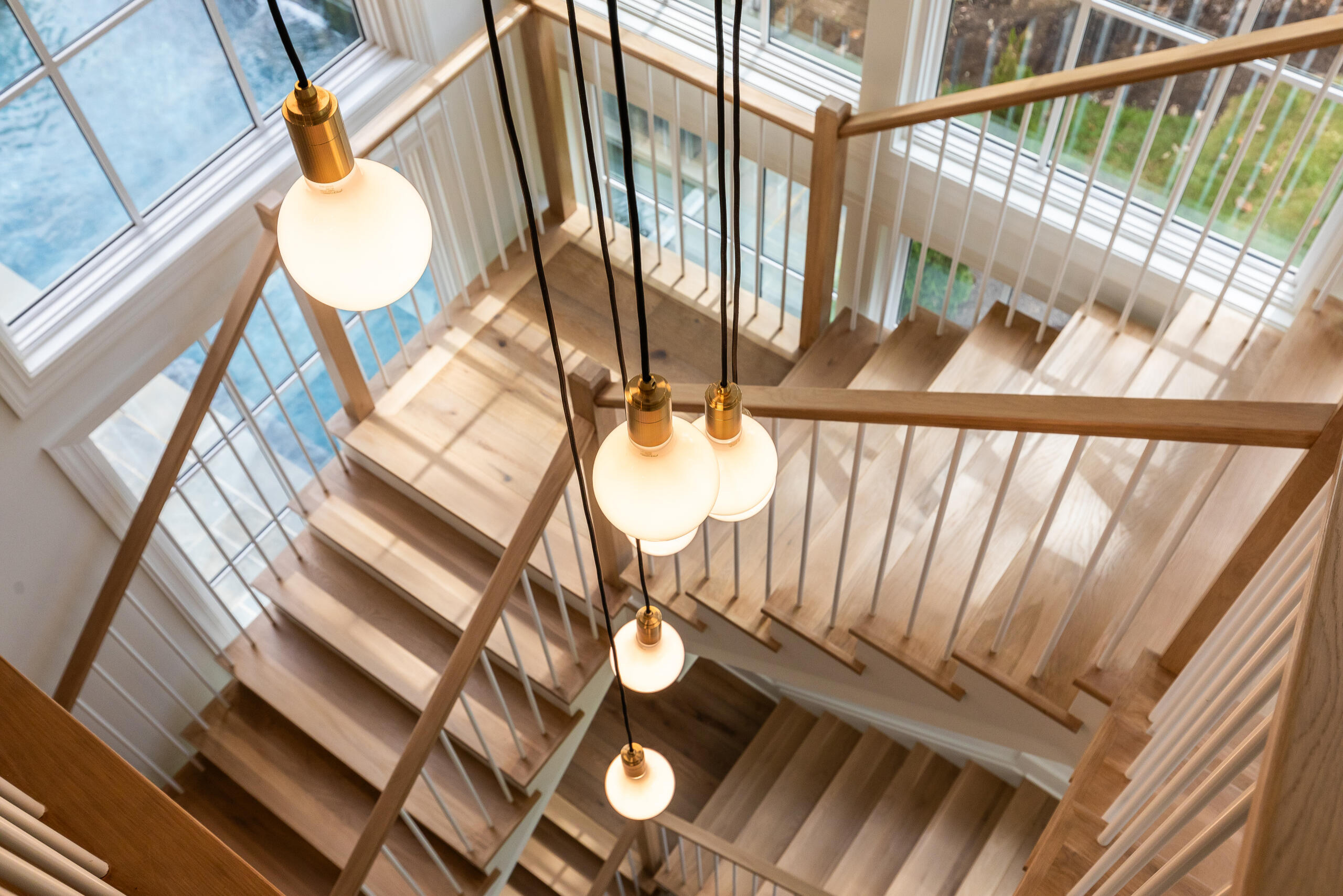 Project #152 | Three-Story White Oak Staircase with a Pendant Chandelier