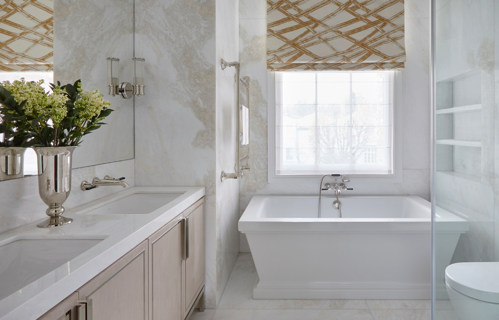 Design ideas for a transitional bathroom in London with a freestanding tub.