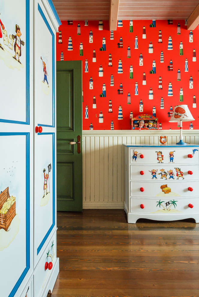 Photo of a transitional kids' bedroom for kids 4-10 years old in Other with red walls and medium hardwood floors.