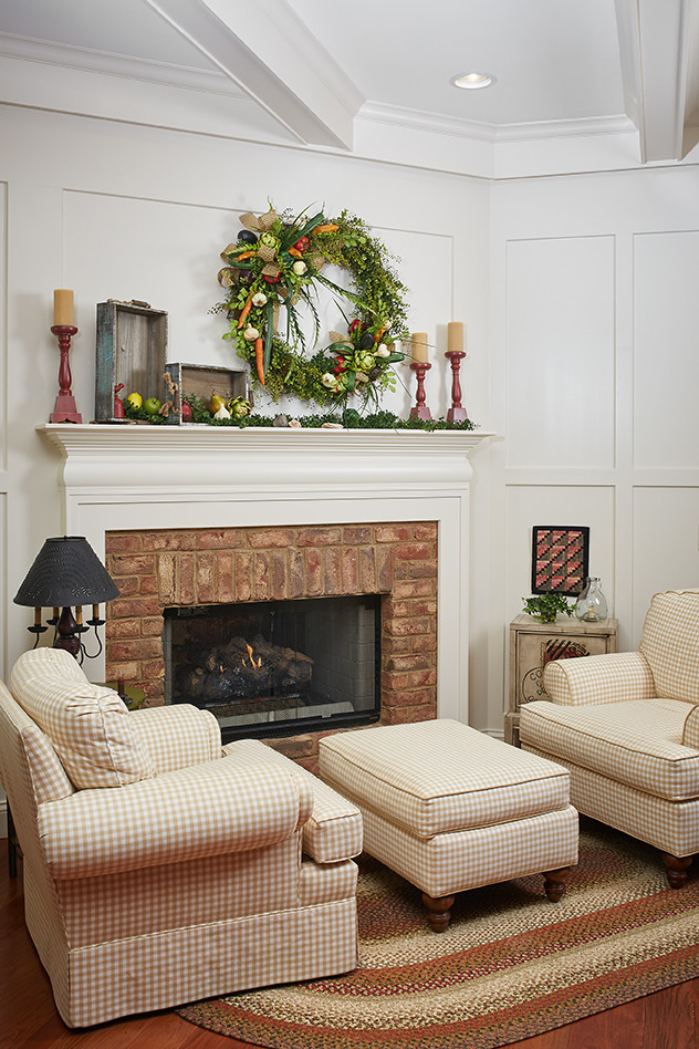 Photo of a traditional family room in Grand Rapids with a standard fireplace, a brick fireplace surround, a concealed tv, coffered and panelled walls.