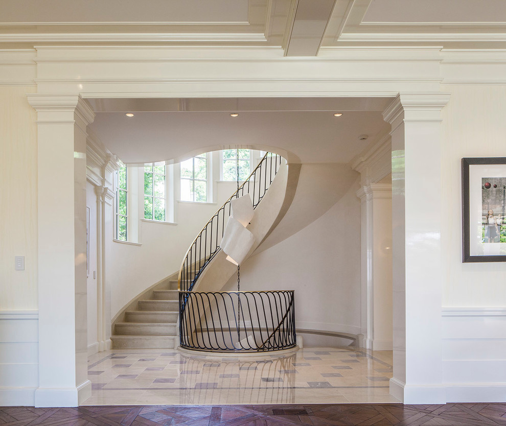 Inspiration for a traditional curved staircase in New York with metal railing.