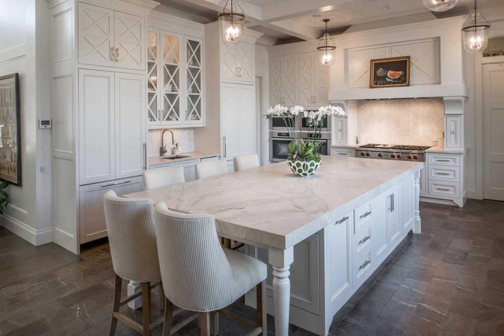 Inspiration for a large traditional l-shaped open plan kitchen in Austin with recessed-panel cabinets, white cabinets, white splashback, marble splashback, stainless steel appliances, marble floors, with island, black floor and grey benchtop.