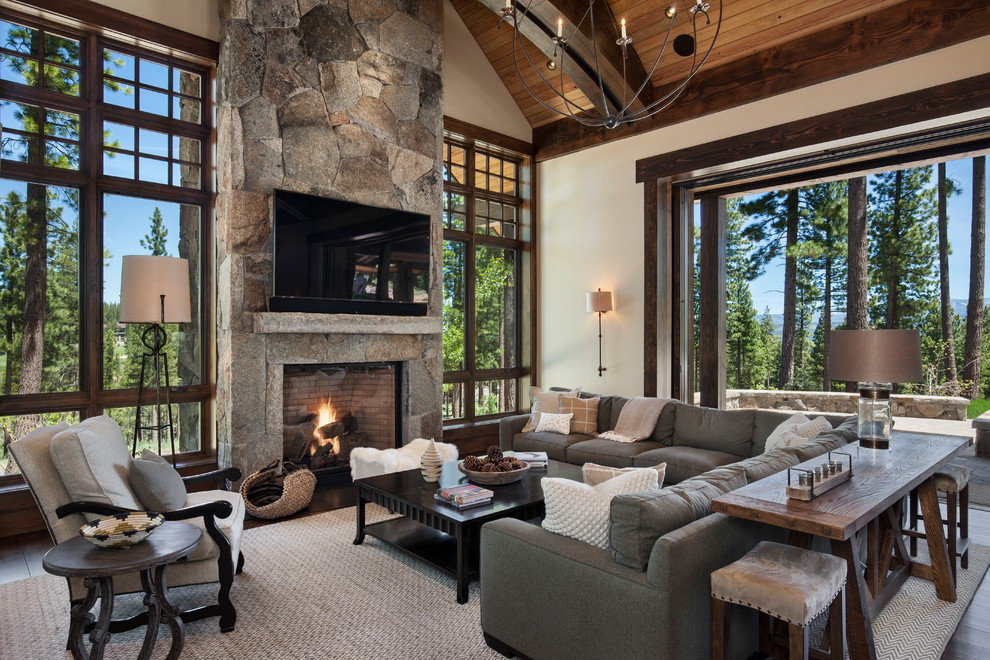 Design ideas for a large country open concept family room in Sacramento with white walls, dark hardwood floors, a standard fireplace, a stone fireplace surround and a wall-mounted tv.