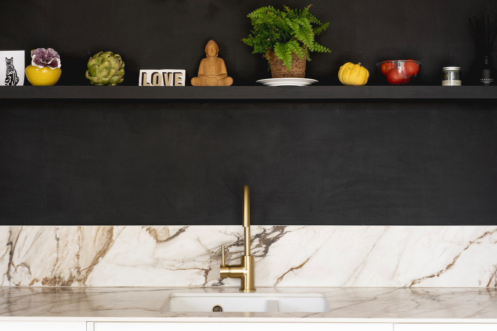 Inspiration for a small contemporary kitchen in Other with a submerged sink, marble splashback and feature lighting.