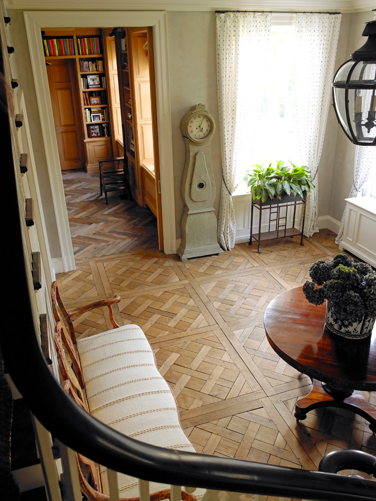 This is an example of a large traditional vestibule in New York with grey walls and medium hardwood floors.