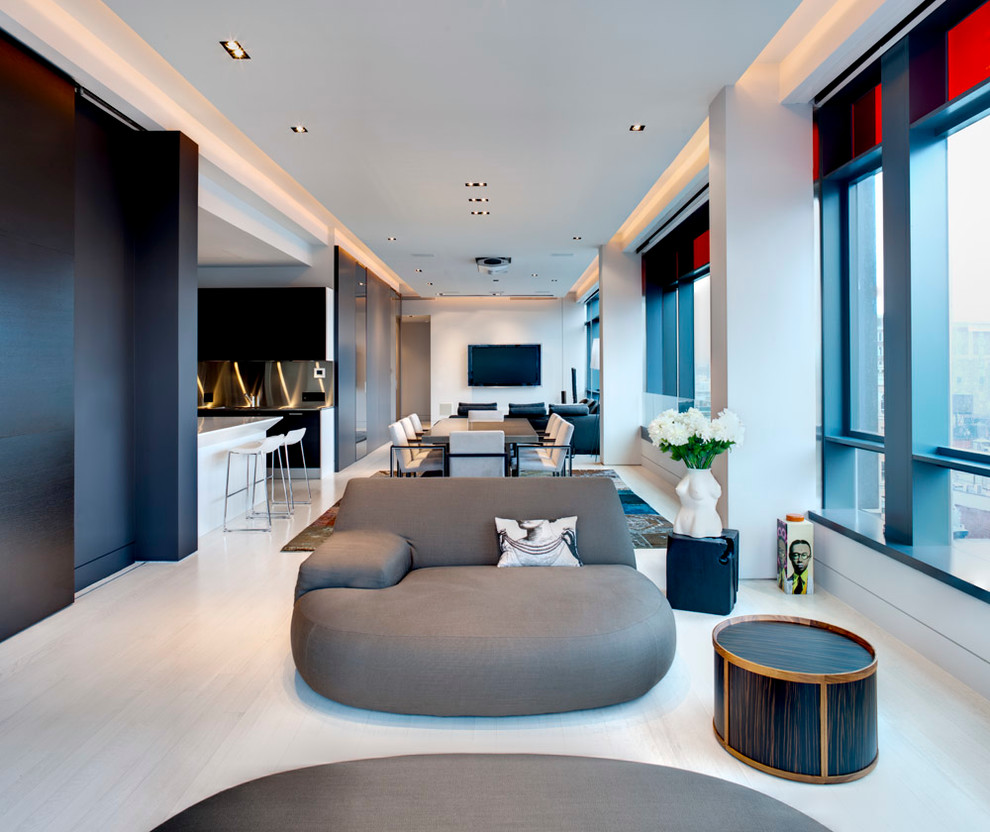 Mid-sized contemporary open concept living room in New York with grey walls, light hardwood floors, a concealed tv and beige floor.