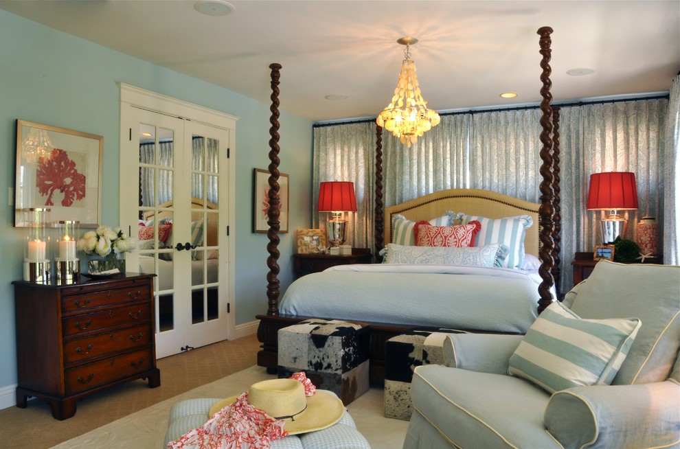 This is an example of a large beach style master bedroom in San Diego with blue walls.