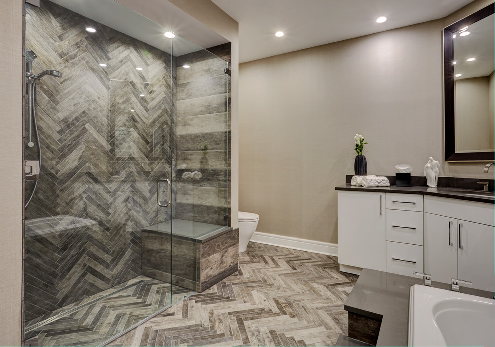 Design ideas for a contemporary master bathroom in Chicago with flat-panel cabinets, white cabinets, a drop-in tub, a curbless shower, a one-piece toilet, beige tile, porcelain tile, grey walls, travertine floors, an undermount sink, engineered quartz benchtops and a hinged shower door.