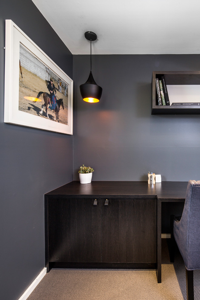 This is an example of a mid-sized contemporary study room in Brisbane with grey walls, carpet and a built-in desk.