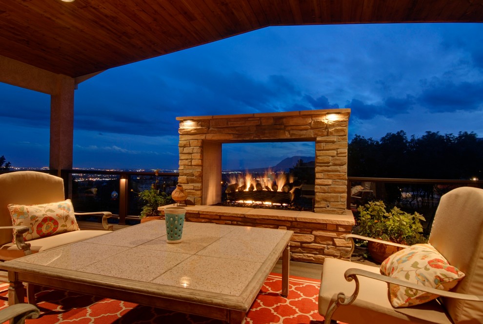 Large transitional backyard stone patio photo in Denver with a fire pit and no cover