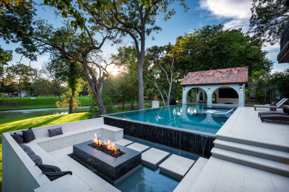 Inspiration for a mid-sized backyard rectangular pool in Houston with a hot tub and natural stone pavers.