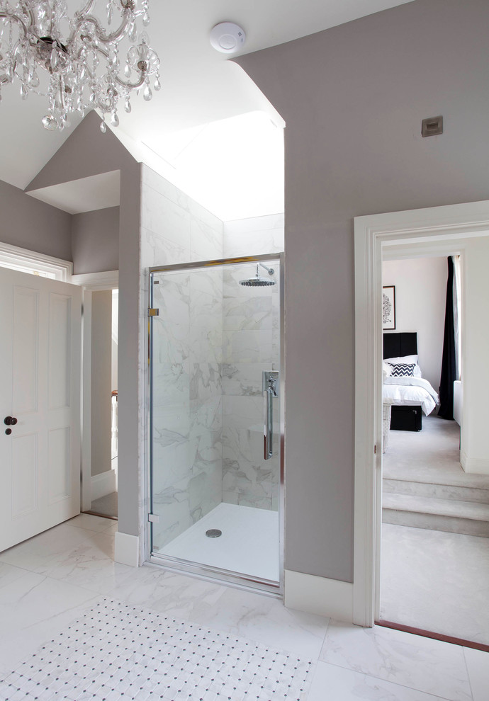 Photo of a large transitional kids bathroom in Belfast with furniture-like cabinets, white cabinets, a freestanding tub, a curbless shower, white tile, porcelain tile, grey walls, porcelain floors and marble benchtops.