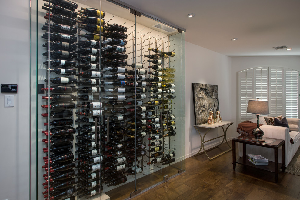 Photo of a small modern wine cellar in Phoenix with light hardwood floors and storage racks.