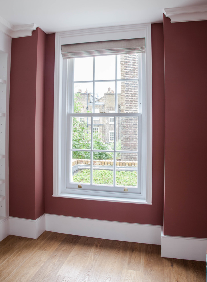 Photo of a victorian living room in Other with pink walls.