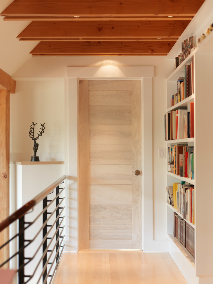 Country hallway in Burlington with white walls and light hardwood floors.